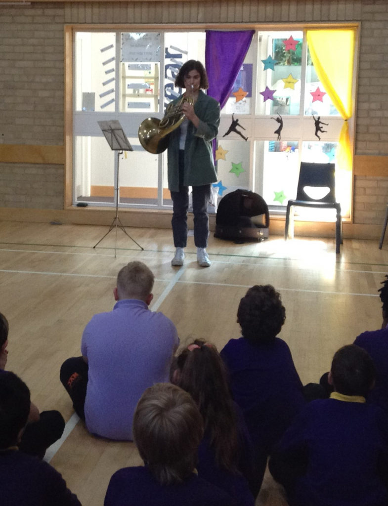 Flora playing the French Horn