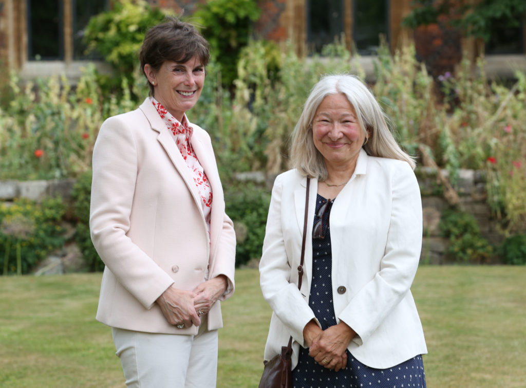 Heather Hancock (left) standing next to Mary Short (right) in the garden at St John's.