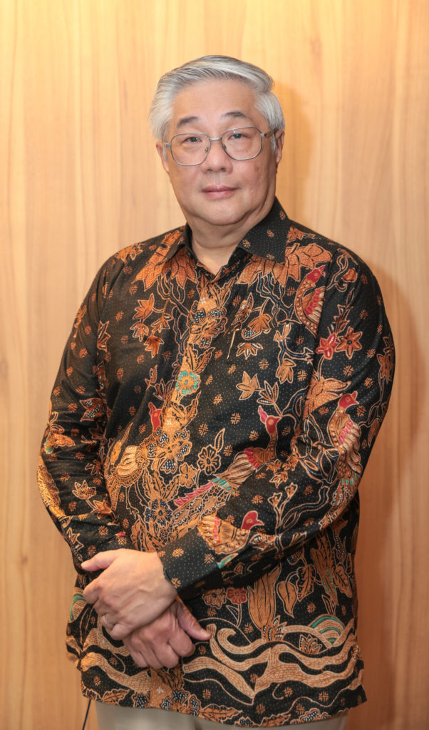 Walter Woon, wearing a colourful patterned shirt.
