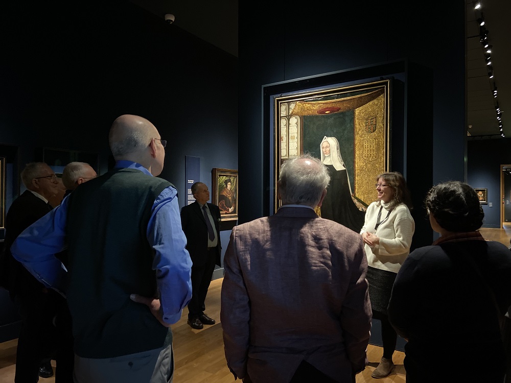 Members of the Beaufort Society gather around a curator who is talking about the portrait.