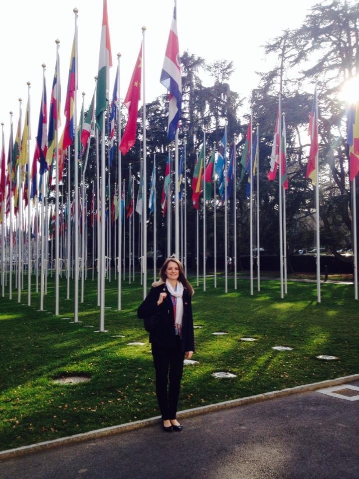 Emily standing in front of lots of national flags